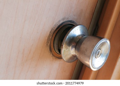 Broken Door Handle On Brown Door With Wood Pattern