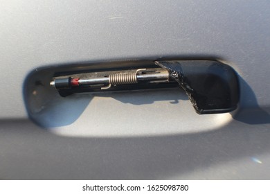 A Broken Door Handle On Gray Car.