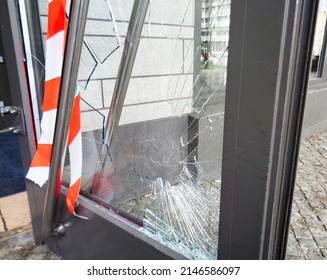 Broken door with shattered glass and barrier tape
