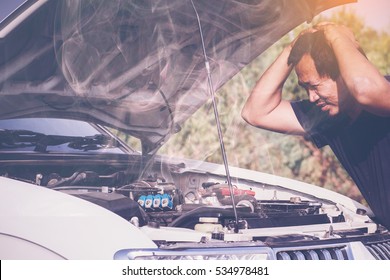 A Broken Down Car, Engine Open And Smoking, Driver Looking At The Engine And Do Nothing.