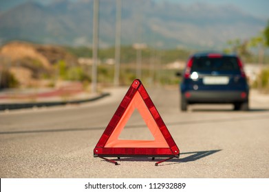 Broken Down Car Marked By A Red Warning Triangle