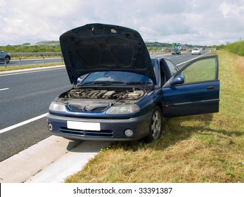 Broken Down Car On The Side Of A Busy Road