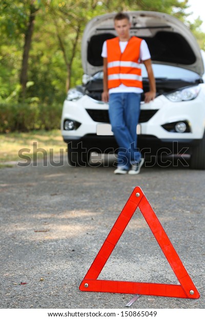 Broken down car with
red warning triangle
