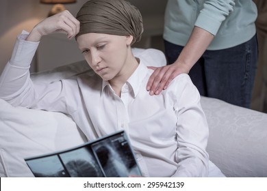 Broken Down Young Cancer Woman Sitting At Home With Friend