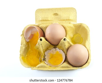 Broken Egg In A Carton Box Isolated On White Background