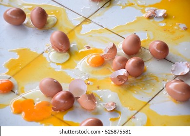 Broken Egg On Tile Floor.