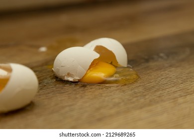 Broken Egg That Fell On A Wooden Floor.