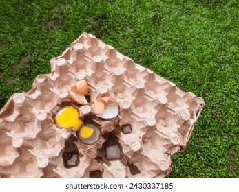 Broken eggs yoke and eggshells. Broken eggs on paper egg panel 