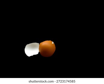 Broken eggshell on dark background, food waste and fragility concept