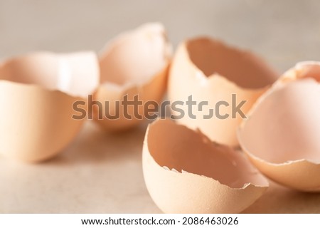 Broken eggshells on a light table. Close-up, selective focus.