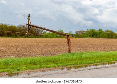 Broken Electrical Utility Pole And Power Lines Due To Severe Weather. Concept Of Storm Damage, Power Outage, And Electricity Danger.