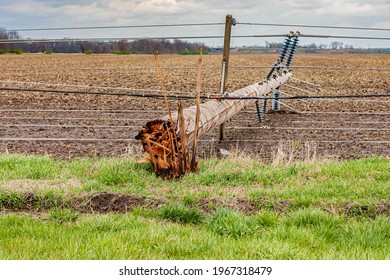 Broken Electrical Utility Pole And Power Lines Due To Severe Weather. Concept Of Storm Damage, Power Outage, And Electricity Danger.