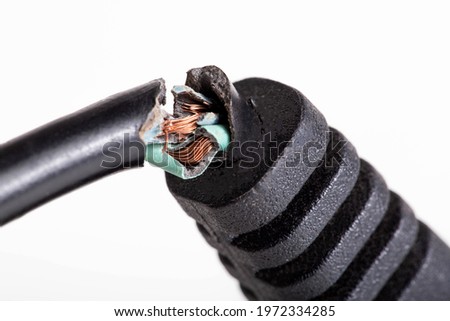 Broken electrical wire with a plug on a white background, isolate, close-up. Electric shock, defective