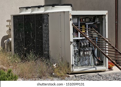 Broken External Air Conditioning Unit Electronics With Metal Ladder