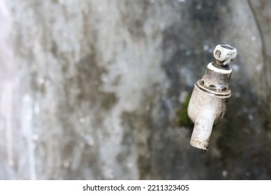 A Broken Faucet Attached To The Wall