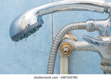 Broken faucet with shower in bathroom