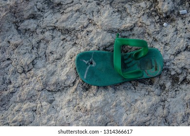 Broken Flip Flops On White Stone