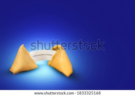 broken fortune cookie with fortune message, surprise in the near  future, modern gaphical fortune telling concept, happy chinese new year greeting card