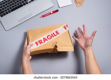 Broken Fragile Parcel, Torn Cardboard Box On Office Desk