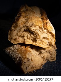 Broken Fresh Baguette On Dark Background