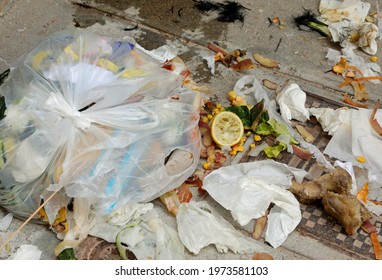 Broken Garbage Bag Abandoned On The Street With All The Things Scattered On The Ground Sign Of Incivility And Decay