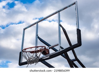 Broken Glass Backboard And Broken Hoop On The Basketball Court