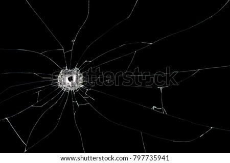 Broken glass background with bullet hole. Isolated on black background.