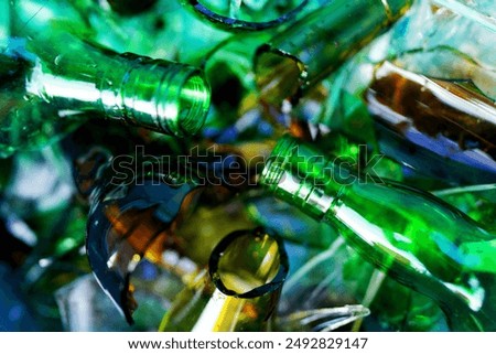 Broken glass bottles, background, texture. Broken glass bottles for recycling. Background of broken glass for recycle. Recyclable garbage, recovery of waste. Broken glass Waste Recycled. 