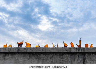 Broken Glass Bottles Covered Concrete Fences For Anti Climb Concept, Sharp Pieces On Top Edge Brick Wall For Protection Private Zone, Cheap Security Of Building Detail With Beautiful Blue Sky Space