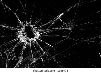broken glass - cracked with hole over black