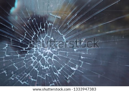 broken glass. Criminal incident at the bus stop. Hole and cracks in the glass of a city bus stop. Cracked glass Texture. Cracked glass with a hole from a bullet