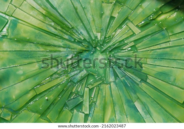 Broken glass and green water
paint
