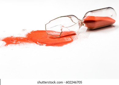 broken glass hourglass with red sand on a white background , time concept