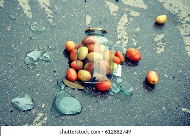 A Broken Glass Jar With Tomatoes