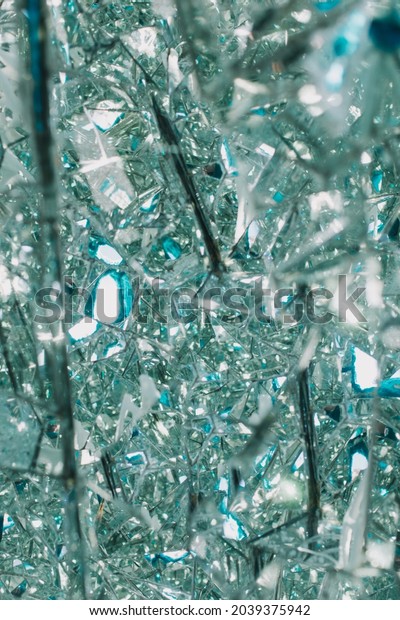 Broken glass or mirror texture with\
bokeh. Abstract winter backround. Ice and cold\
concept