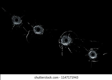 Broken Glass Multiple Bullet Holes In Glass Isolated On Black