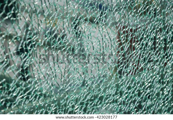 Broken glass screen wall at train station.\
Selective focus.