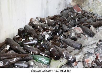 Broken Glass Soda Bottle On The Ground.