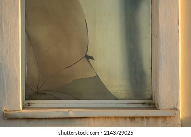 Broken Glass In A Window Frame With Morning Light