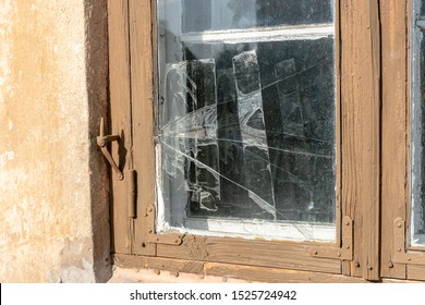 Broken Glass In The Window Frame And Sealed With Tape.