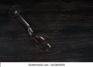 Broken Glass For Wine On A Dark Wooden Table