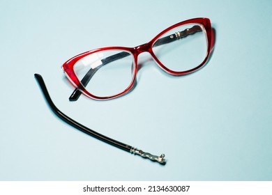 Broken Glasses Isolated On Gray Background. Red Plastic Frame  