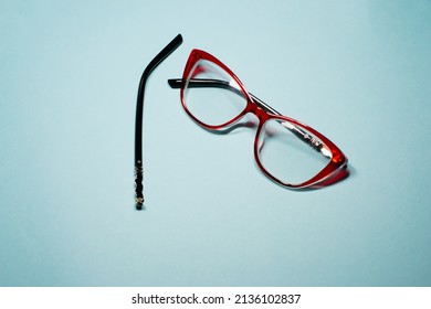 Broken Glasses Isolated On Gray Background. Red Plastic Frame  