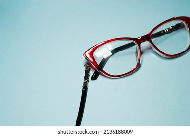 Broken Glasses Isolated On Gray Background. Red Plastic Frame