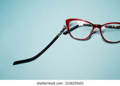 Broken Glasses Isolated On Gray Background. Red Plastic Frame  