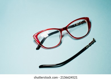 Broken Glasses Isolated On Gray Background. Red Plastic Frame