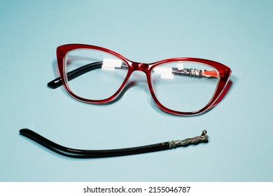 Broken Glasses Isolated On Gray Background. Red Plastic Frame