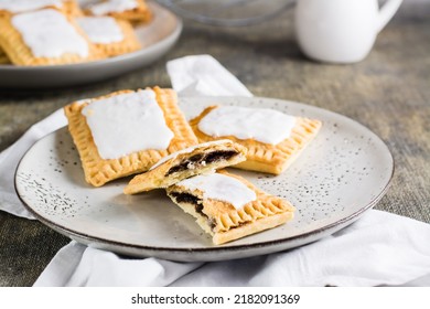 Broken Glazed Homemade Pop Tarts On A Plate On The Table. American Pastry.