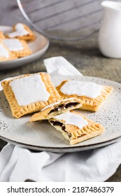 Broken Glazed Homemade Pop Tarts On A Plate On The Table. American Pastry. Vertical View