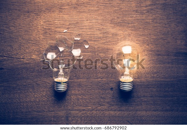 Broken and\
Glowing light bulb comparison concept, problem and solution,\
failure and success, learning from\
mistake
